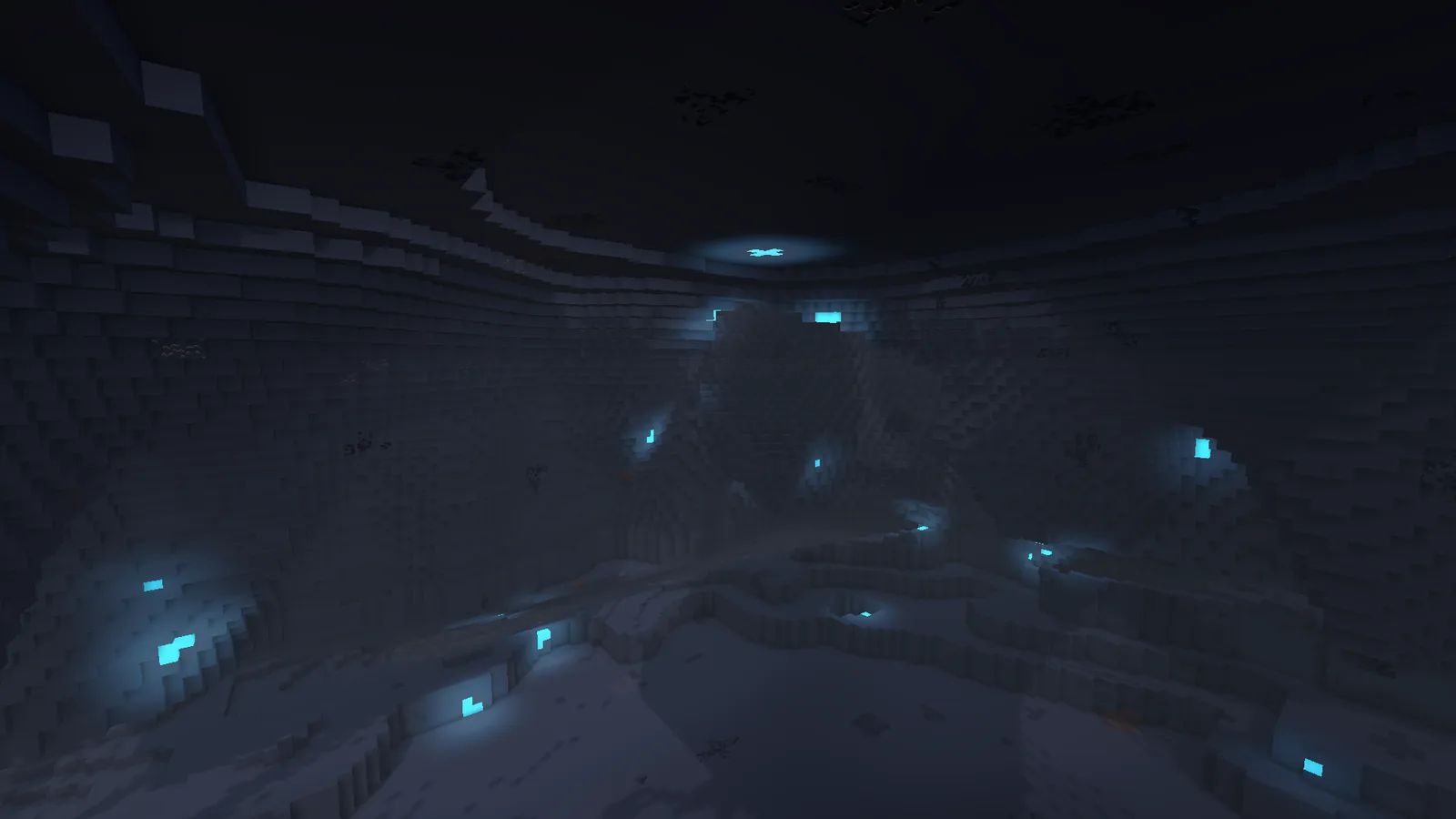 A dark cavern hall has cyan ore glowing in its walls.
