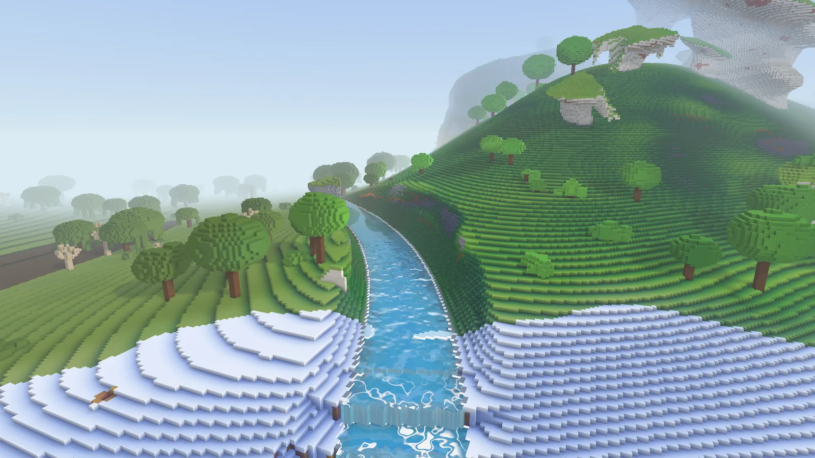 A river steps down in cascades between green hills and snow.